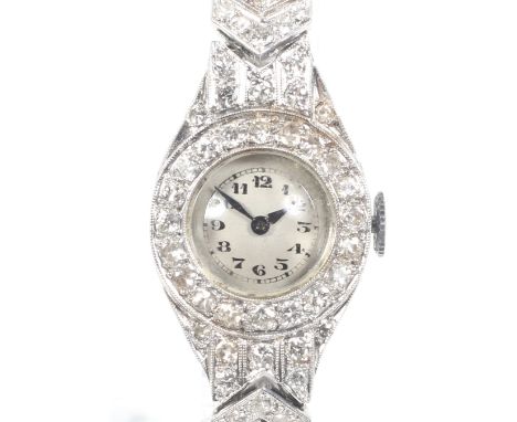 Cyma, an Art Deco lady's platinum and diamond bracelet watch, circa 1930. The small silvered dial with black-painted Arabic n