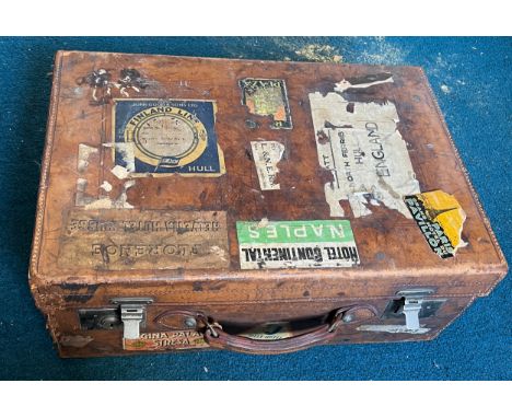 A vintage leather suitcase with luggage labels. 56cm x 38cm x 21cm. 