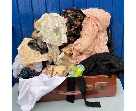 A vintage suitcase and contents to include early 20thC dress trimmings, fabric, beads etc. Suitcase size 60 x 30 x 18cm.