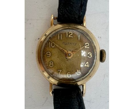 A 9 carat gold cased ladies Rotary wristwatch on black leather strap. Total weight 10.4gm. 