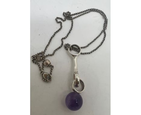 A Georg Jensen sterling silver and amethyst pendant. Chain length 44cm. 