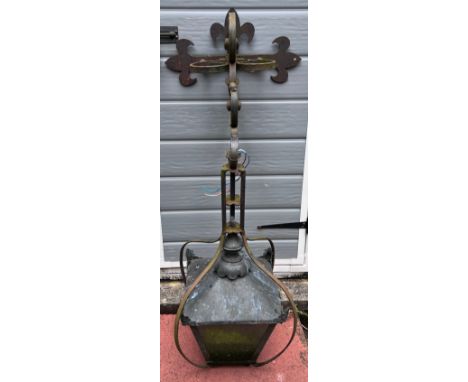 A wall mounted metal outdoor lamp on bracket. 100cm h from bracket. 