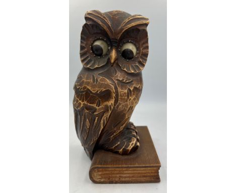 A German carved owl mantel clock, the owl seated on a book, having movement in his eyes. Stamped Germany to reverse.&nbsp;18.