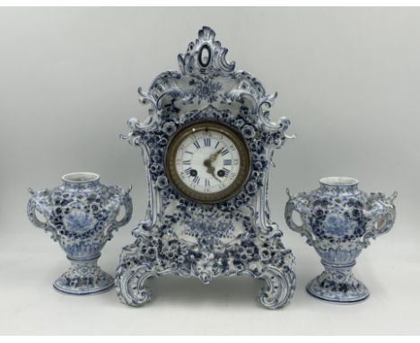 A 19thC blue and white porcelain Continental clock garniture, comprising clock&nbsp; 38.5cmwith two vases 17cm h. Striking on