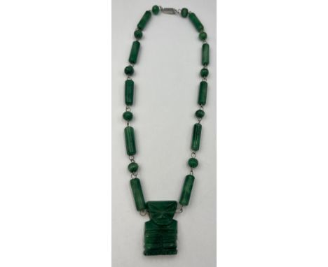 A jade and silver 1960’s necklace from Mexico with a 4cm x 2cm ‘chipcha’ motif centrepiece. 50 cm l. 