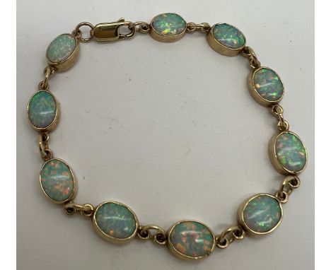 A 9 carat gold and opal bracelet. Weight 8.8gm. 17cm l. 