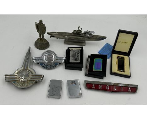 A miscellany lot to include 2 boxed zippo lighters, unboxed Zippo, a Comoy's boxed lighter and another, a lighter in the shap