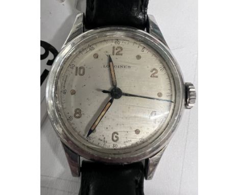A gentleman’s vintage Longines wristwatch on a black leather strap.