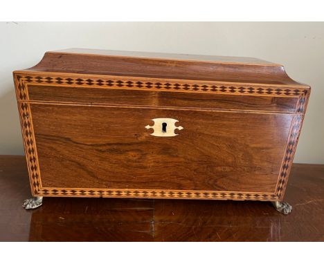 A good quality mahogany and inlaid tea caddy with ivory escutcheon and lions paw feet with lion mask handles to sides. Two li