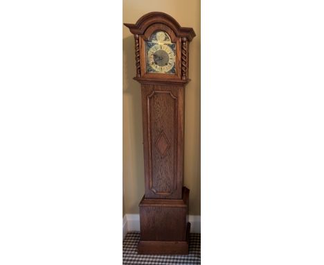 An oak grandmother clock with barley twist supports to hood. 169cm h. 