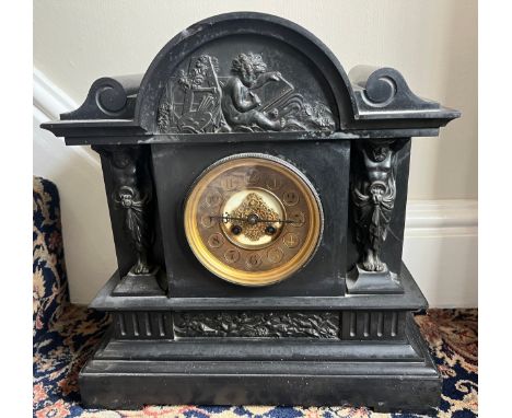 A 19thC slate mantel clock with decorative panel to top and two caryatids to either side of brass dial. 41 h x 38 cm w. 
