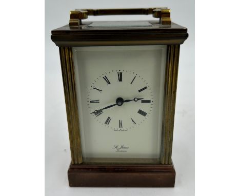 A Brass Mantle Carriage Clock with roman numeral dial with gilt case and bevelled glass windows surrounding. St. James London