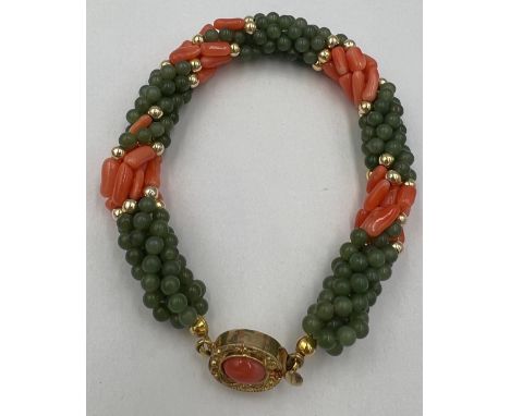 A coral and jade bead twisted bracelet with yellow metal clasp. 18cm l. 