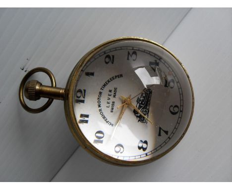 A brass cased Superior Motor Timekeeper Lever Swiss-made, the white dial with black Arabic numerals, bullseye glass, in worki