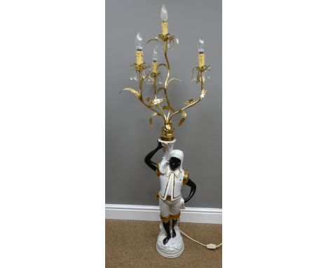 Ceramic figural standard lamp in the form of a Blackamoor beneath a gilt metal four branch candelabra, H129cm    Condition Re