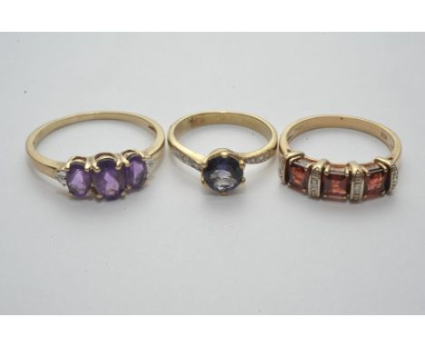 A collection of three 9ct gold dress rings including amethyst and garnet set 