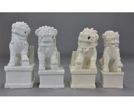 Four 19th century Chinese blanc de Chine lion dog joss stick holders. 14cm - 16cm tall