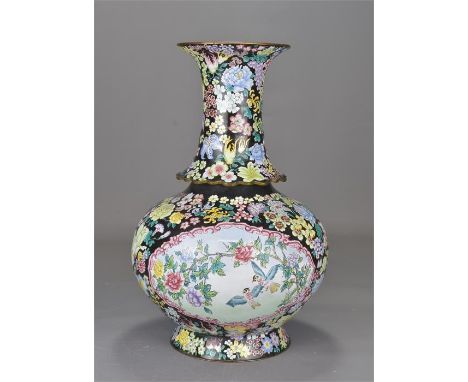 A large 20th century Chinese Canton enamel vase decorated with flowers and panels with bird scenes. 36cm tall