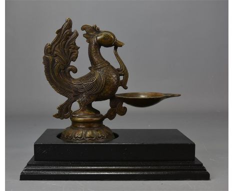 A Middle-Eastern oil lamp in the form of a bird on stand. 18cm x 20cm