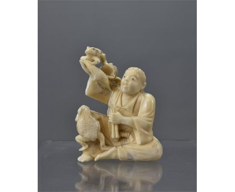 A 19th century Meiji period Japanese ivory Okimono of a sennin playing with three frogs. 9cm tall