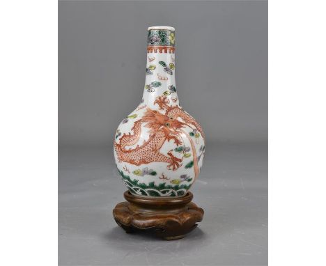 A 19th century Chinese famille rose porcelain bottle vase decorated with dragon and carp on a wooden stand. 15cm tall