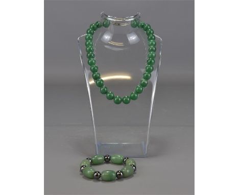 A jade necklace and bracelet. 6cm diameter 