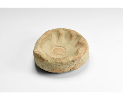 1st-2nd century AD. A ceramic mould-half for the production of oil lamps with basal ring and five short nozzles.  734 grams, 