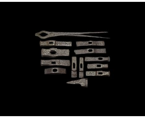 9th-11th century AD. A mixed group of iron items comprising of: long blacksmith's tongues with rune algiz; six hammer heads w