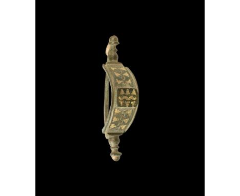 2nd century AD. A bronze 'bridge' brooch with terminal knops to each end, arched body with three panels of inlaid yellow enam