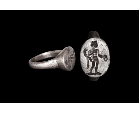 1st century BC-1st century AD. A D-section silver hoop with flared shoulders, discoid bezel with tapering sides, intaglio ima