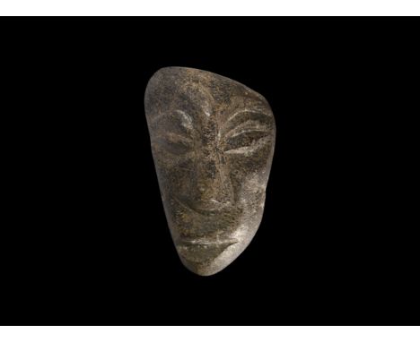 Pliocene Period, 5.2-2.5 million years BP. A Mastodon fossil bone carving from Island of Java with later carved face.  85 gra