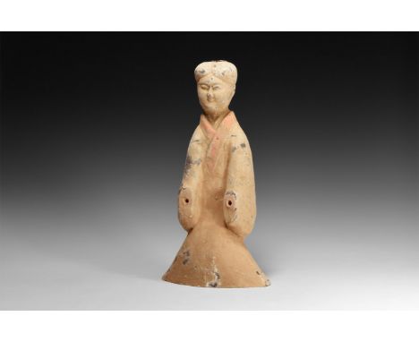 Han Dynasty, 206 BC-220 AD. A ceramic figure of a male servant with hair parted in the centre and swept back over the side of