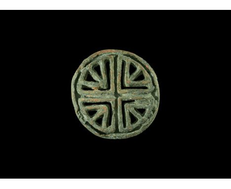 7th-10th century AD. A bronze bread stamp, round with loop handle, openwork design with central cross and interstitial arrowh