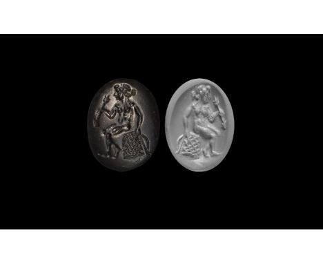 1st-2nd century AD. A discoid plano-convex stone appliqué with intaglio image of Diana seated holding a net and arrow.  2.75 