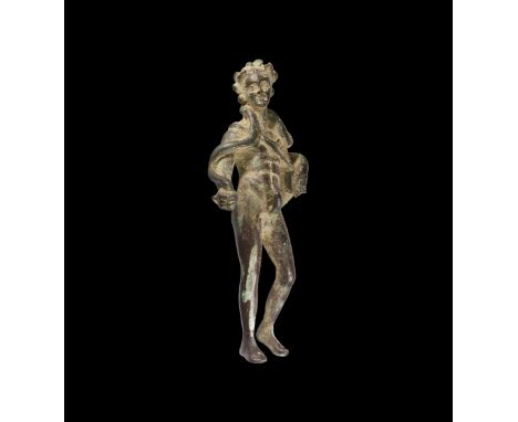 1st-2nd century AD. A bronze statuette of Bacchus (Dionysus) standing and naked apart from a chlamys over the left shoulder; 