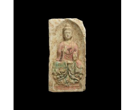 Northern Wei Dynasty, 386-534 AD. A rectangular ceramic brick with arched recess to one face, figure of Buddha with one hand 