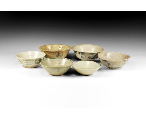 Ming Dynasty, 1368-1644 AD. A mixed group of glazed ceramic bowls and dishes with blue tendril ornament.  1.2 kg total, 11-15