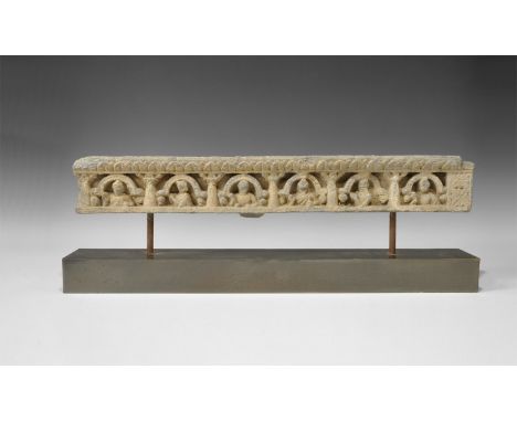 2nd-3rd century AD. A carved schist figural frieze fragment with lotus-petal entablature above six columns with arches in the