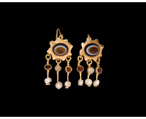 2nd-3rd century AD. A matched pair of gold earrings, each a hollow-formed fluted cup with sardonyx cabochon, three dangles wi