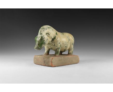 Tang Dynasty, 618-907 AD. A ceramic figure of a standing boar with a jade green glaze and cream slip wash; detailing to the c