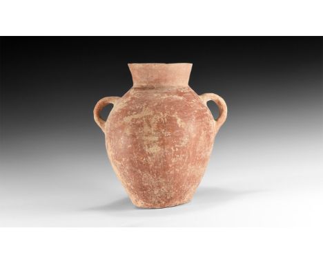3rd millennium BC. A large bulbous ceramic jar with broad neck, two strap handles, flat base.  3.29 kg, 29cm (11 1/2"). Acqui