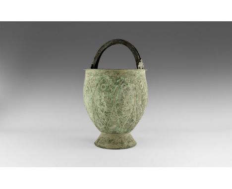 8th-10th century AD. A large bronze vessel with flat rim with two palmette projections for attaching double handles; tapering