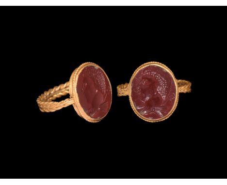 1st century AD. A gold finger ring comprising a doubled ropework band supporting a discoid bezel with beaded wire rim to the 