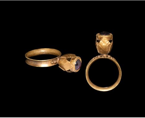 19th century AD. A gold finger ring comprising a C-section hoop with granules to the shoulders, openwork bezel formed as a bu