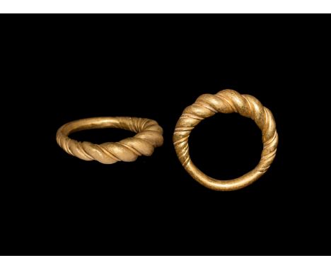 9th-11th century AD. A gold ring comprising an expanding band with modelled spiral detailing with thin wire twist between the