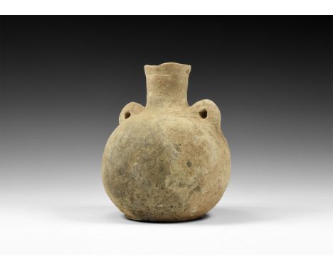 4th-3rd millennium BC. A globular ceramic jar with flattened base, tubular neck with circumferential incised band, two loop h