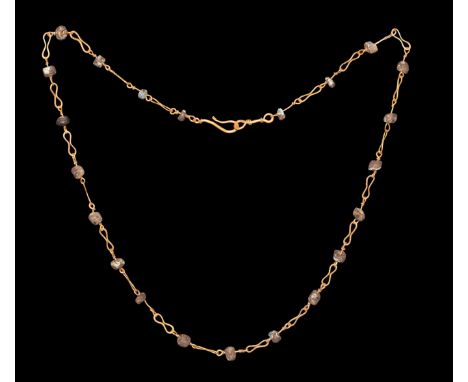 2nd-3rd century AD. A choker-length necklace comprising gold wire links with drum-shaped glass beads, hook-and-eye closure. C