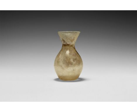 4th-5th century AD. A glass flask with dimple base, globular body, flared rim. Cf. Whitehouse, D. Roman Glass in the Corning 