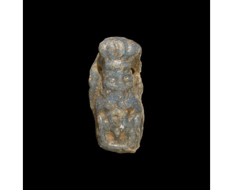 Late Period, 664-332 BC. A deep blue glazed composition D-section figure of Bes in feathered headdress. Cf. Andrews, C. Amule