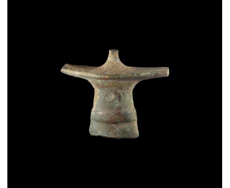 10th century BC. A hollow-formed antenna sword hilt fragment with circumferential hatched bands, flat plaque, median stud; ho
